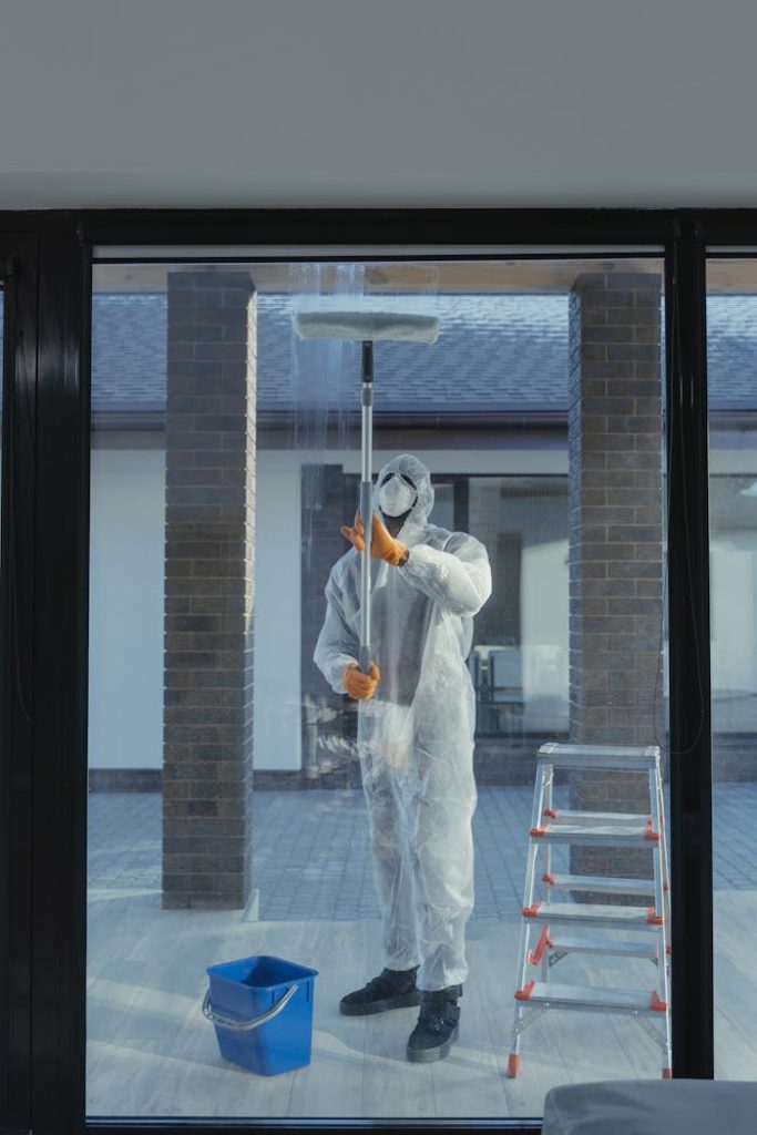 The Art of Drawing Readers In: Your attractive post title goes here A man in full protective gear cleaning a glass window during the daytime.